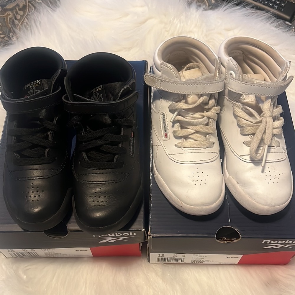 Two pairs of Girls size 10 Reeboks sneakers.